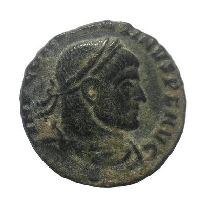 Ancient coin with a profile of a person wearing a helmet on a white background